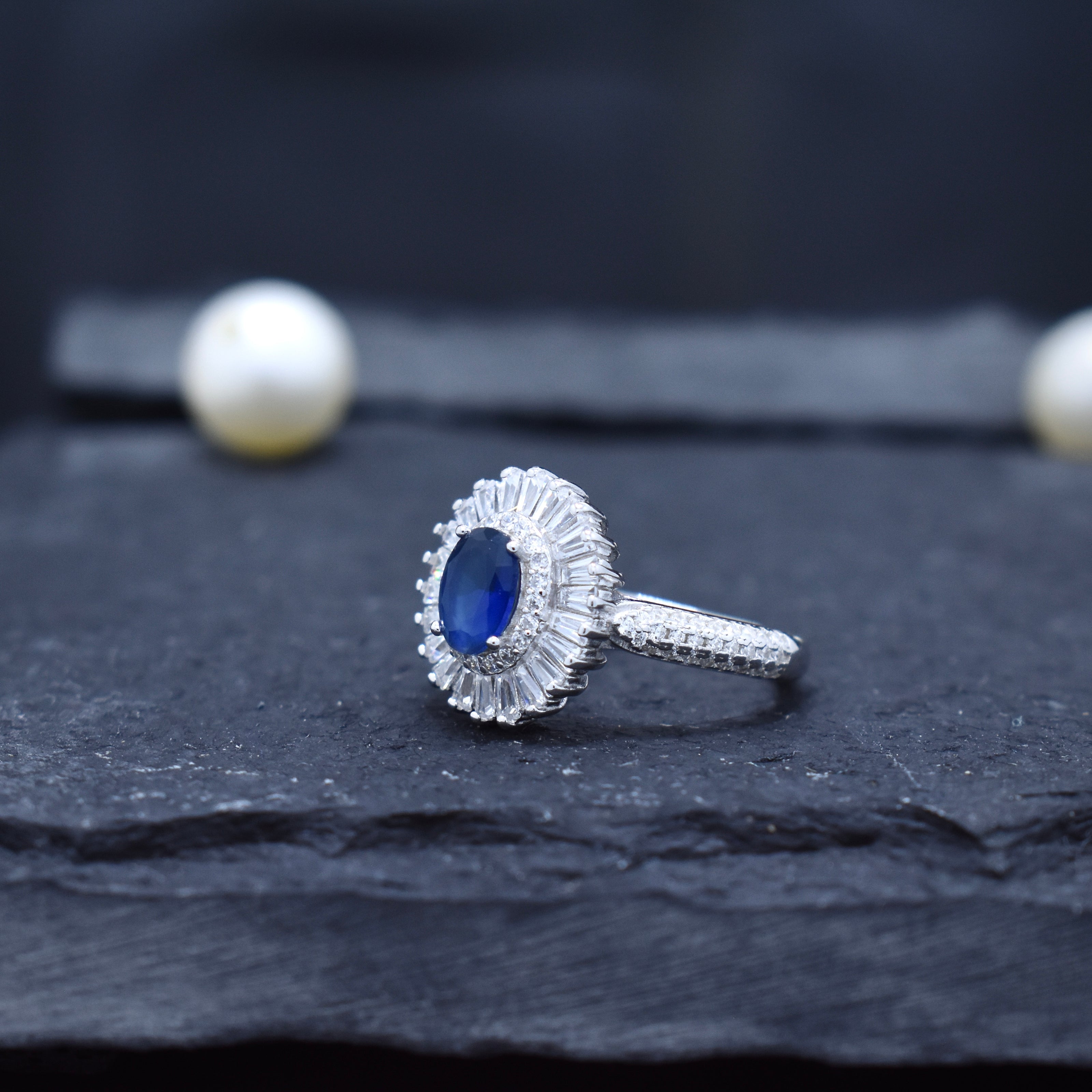 Oval Blue Stone Halo Ring with Baguette Surround