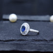 Oval Blue Stone Halo Ring with Baguette Surround