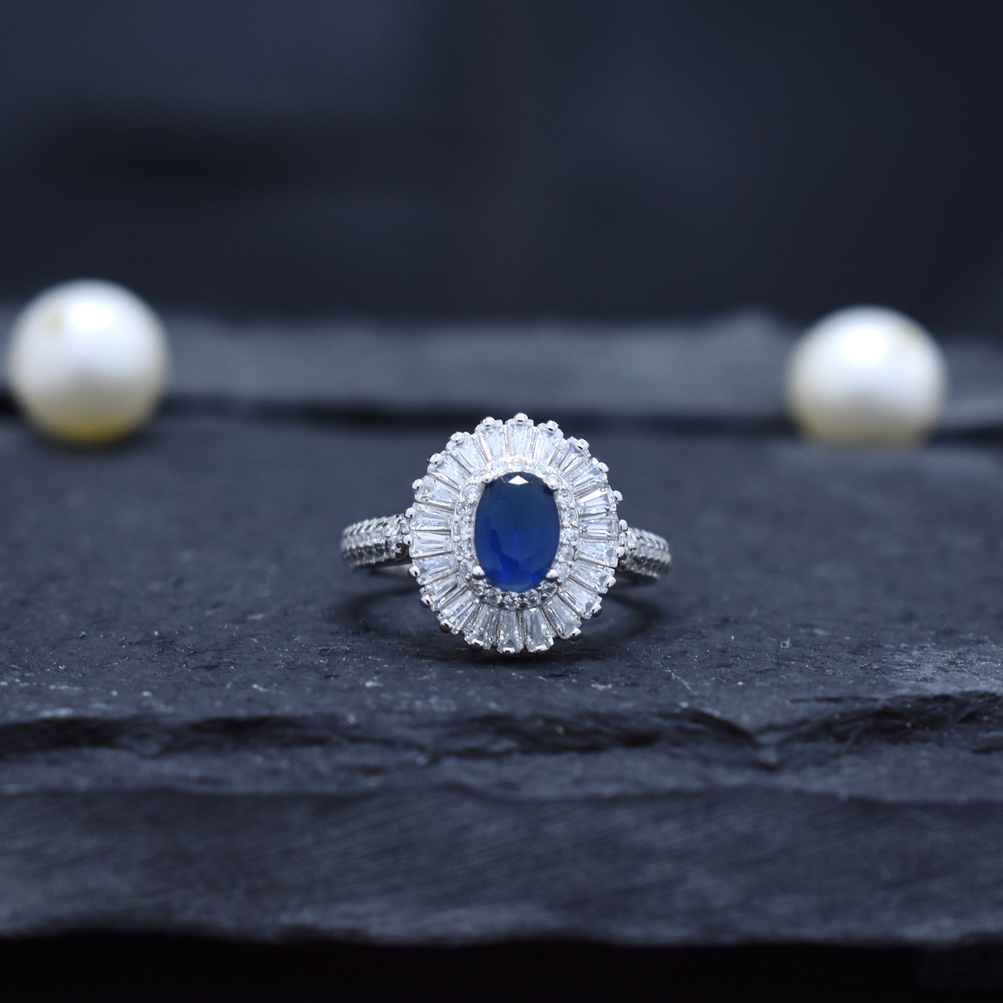 Oval Blue Stone Halo Ring with Baguette Surround