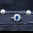 Oval Blue Stone Halo Ring with Baguette Surround