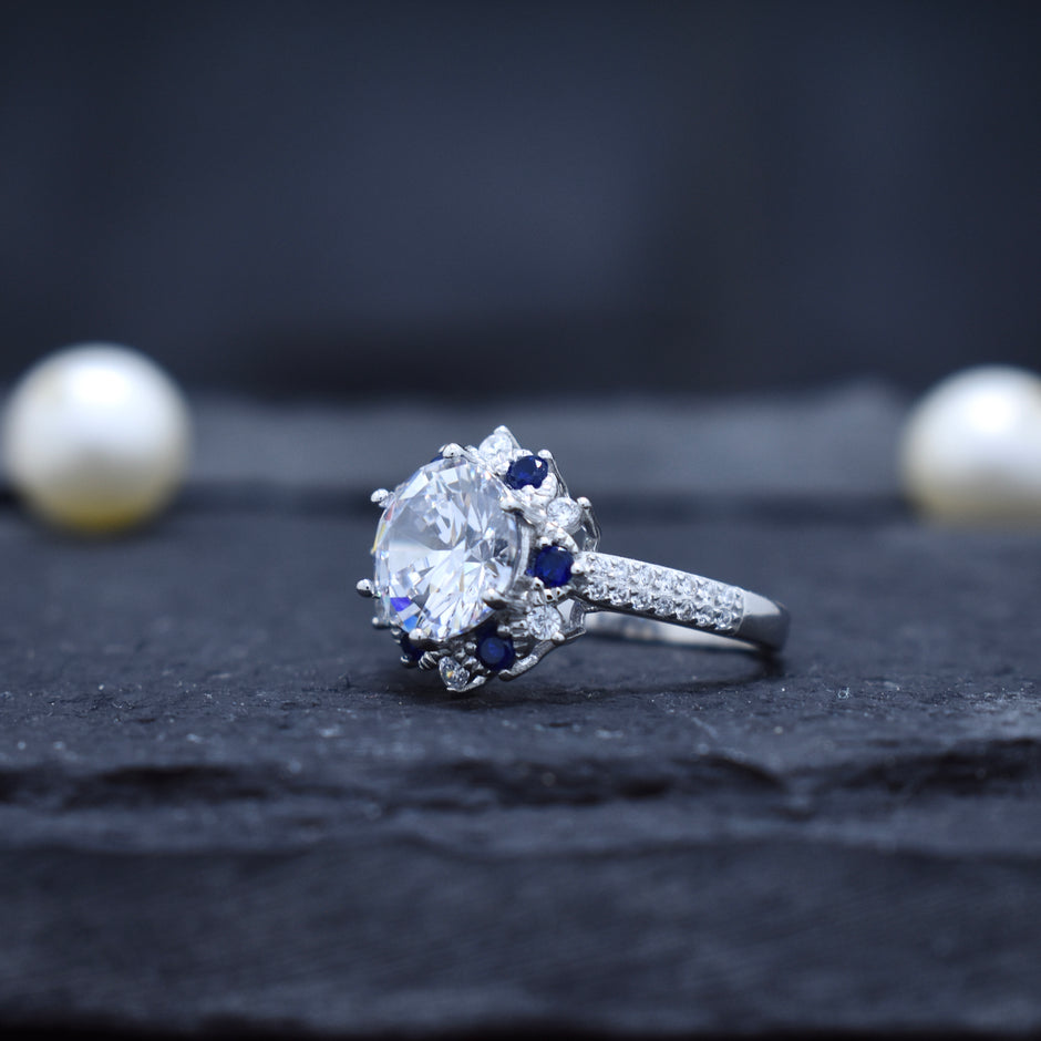 Round Cut Halo Ring with Blue Accent Stones